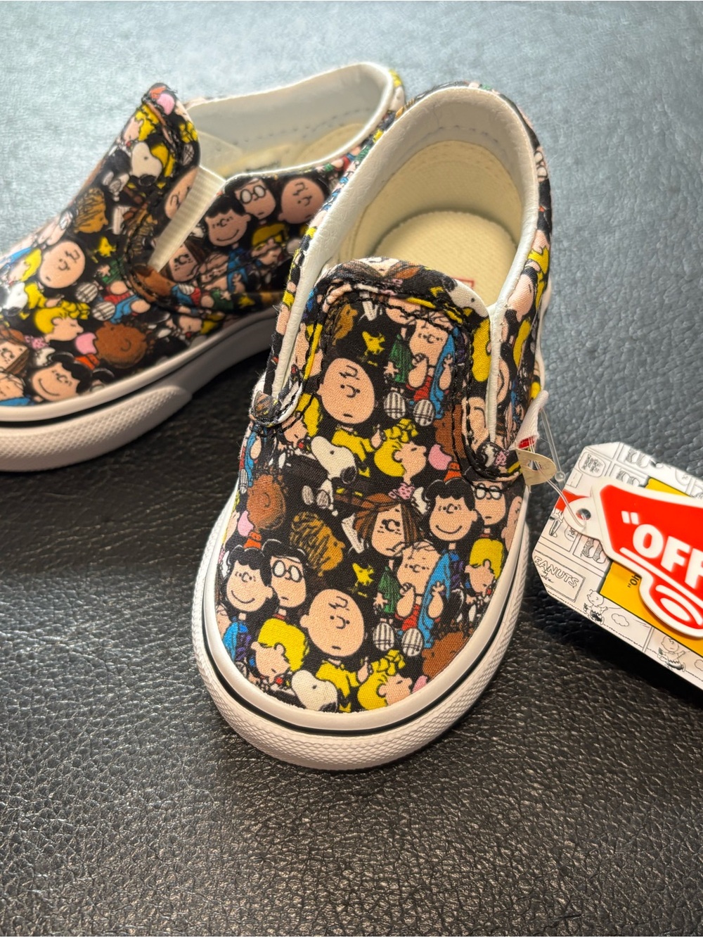 Vans Kids Slip-On Sneakers in Black Multicolor Peanuts Character Print